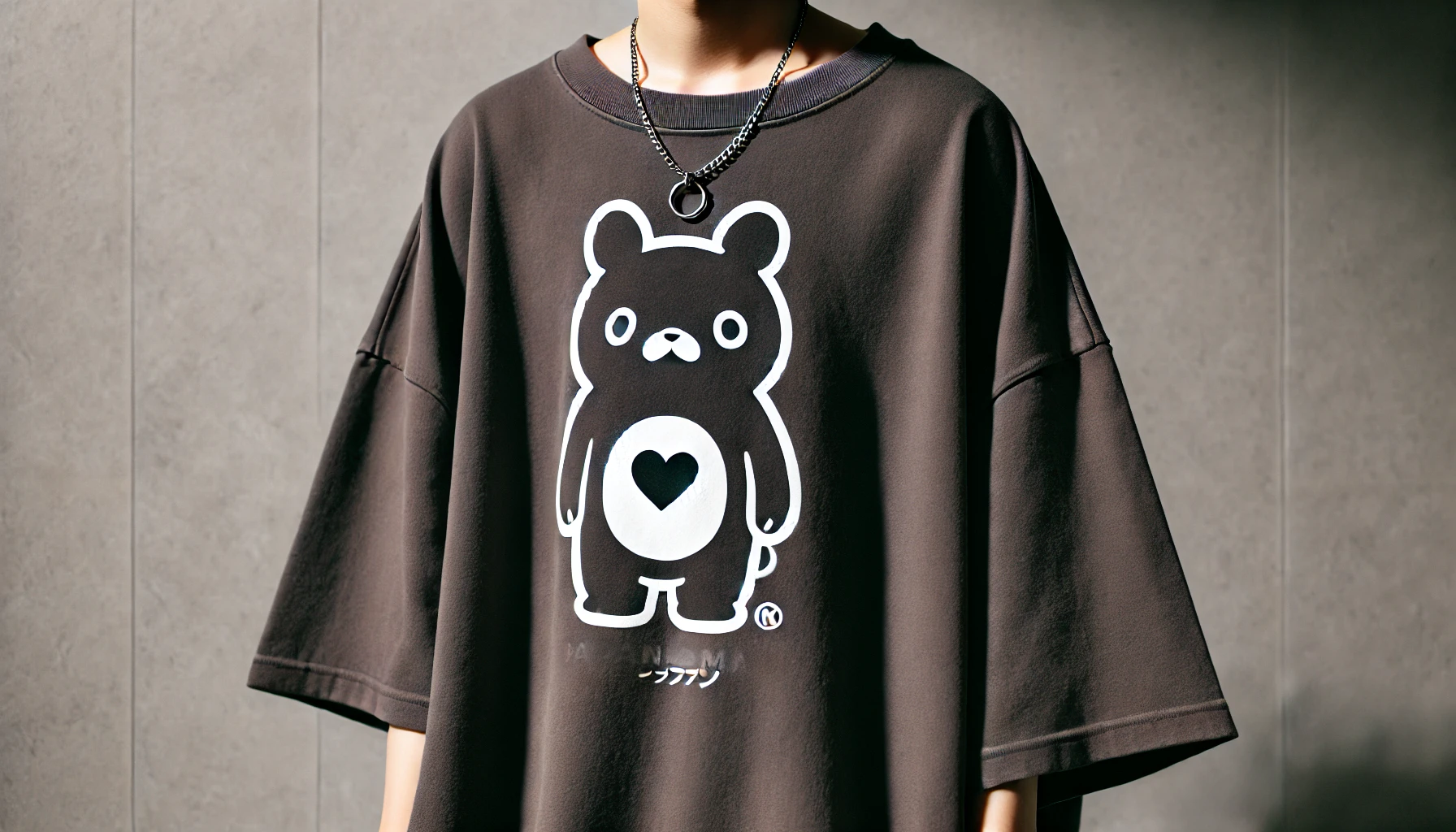 An oversized t-shirt with a large animal and heart logo being worn by a Japanese person. The image focuses on the fit and how the t-shirt conforms to the body, showcasing its comfortable and relaxed style.